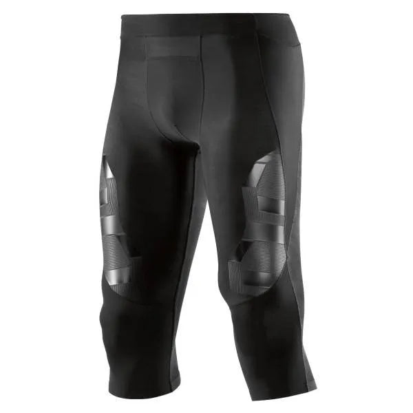 A male athlete wearing black Skins A400 3/4 compression tights, mid-stride during a workout.