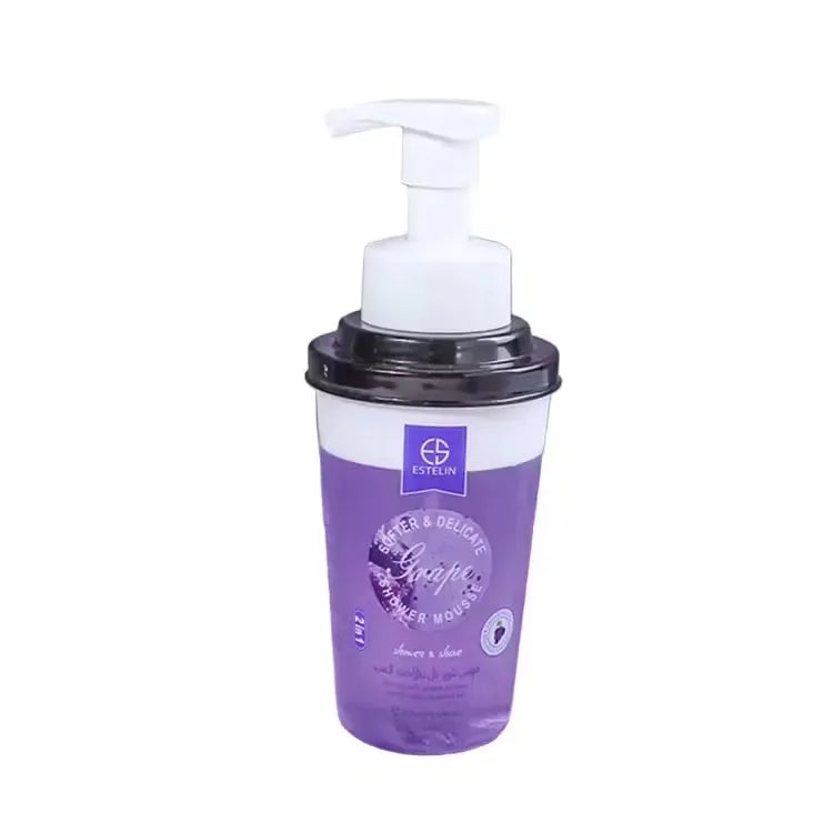 Close-up of Estelin Grape Shower Mousse bottle (370ml) with purple accents and grapes imagery. Light, foamy mousse being dispensed onto hand.