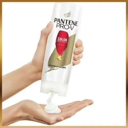 White bottle with blue accents and "Pantene Colour Protect Conditioner" label. Gentle foam being dispensed onto hand.