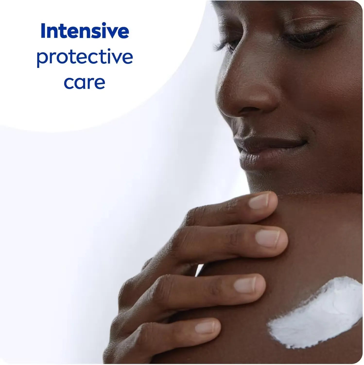 Close-up of a classic blue Nivea Creme tin (250ml) with a woman's hand opening it, revealing the creamy white moisturizer inside.