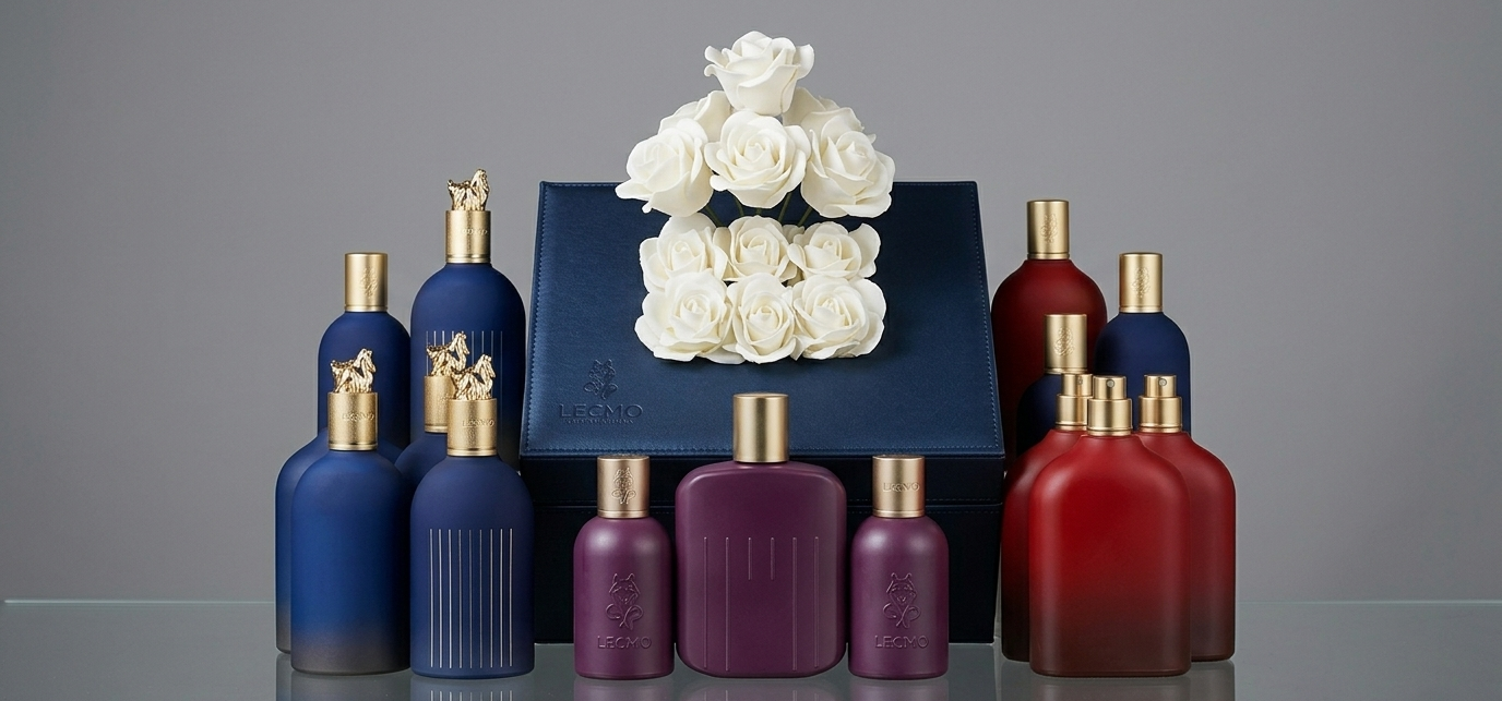 Set of perfume bottles in blue, purple, and red with a decorative box on a gray background