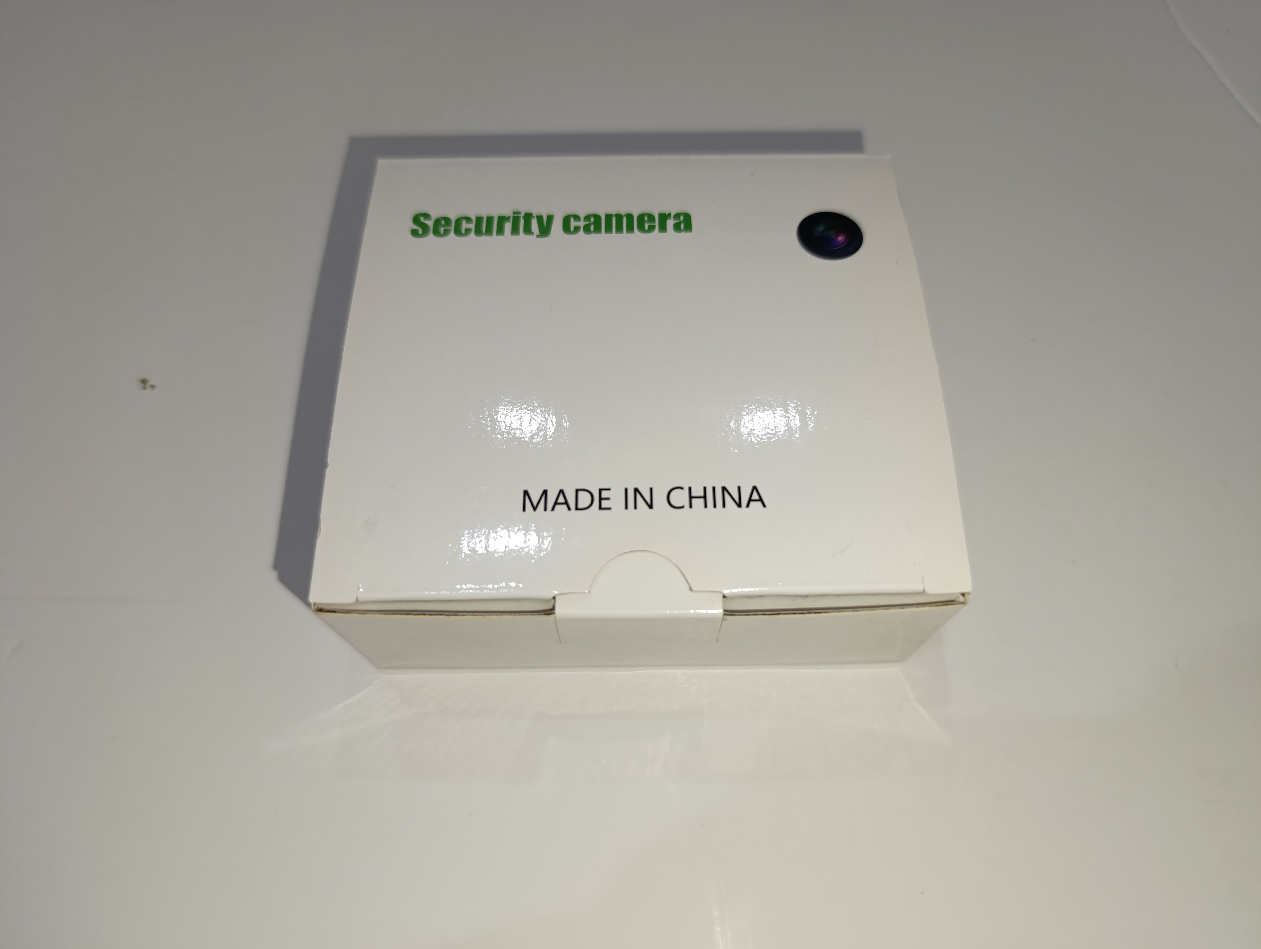 Security camera with base and charging cable