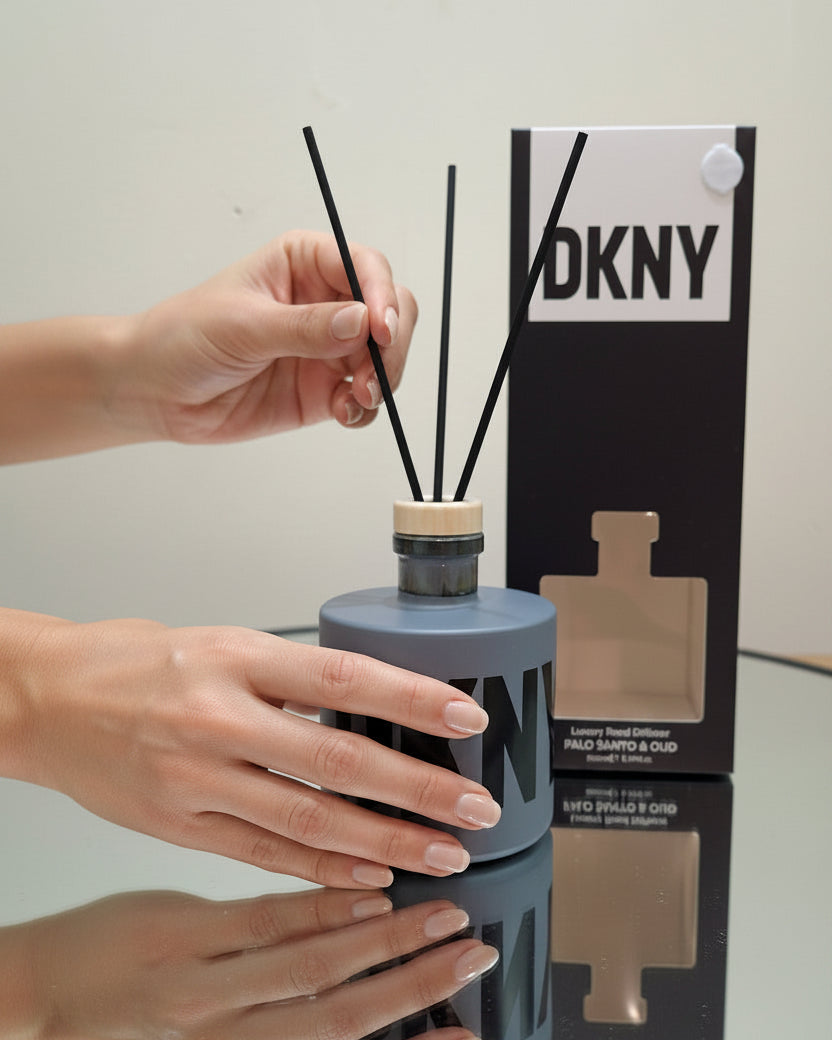 DKNY diffuser with hands interacting and packaging in the background