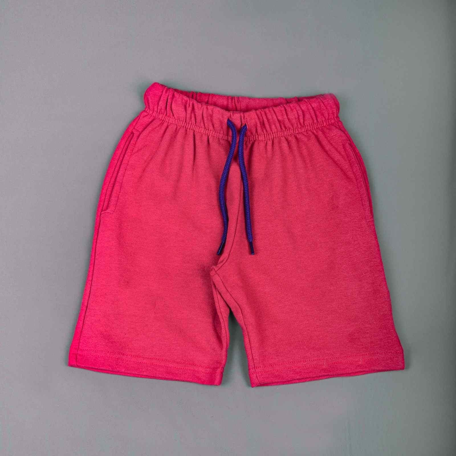 A young boy wearing a black Pebbles Iron Man T-shirt and red shorts, standing confidently with a determined expression.