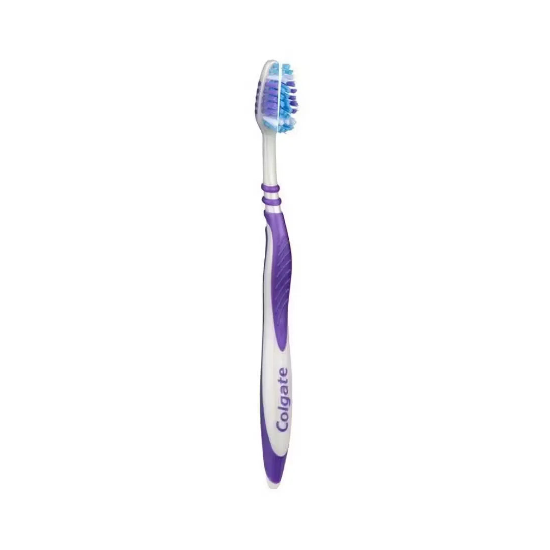 Close-up photo of a purple Colgate Zig Zag toothbrush with medium bristles. Soft focus background highlighting clean, healthy teeth.