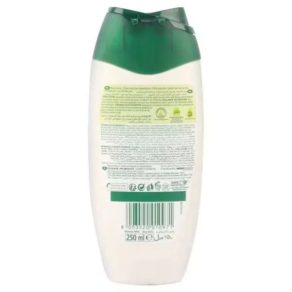 White plastic bottle with blue label and pump, dispensing creamy white moisturizing milk. Label reads "Palmolive Naturals Nourishment Honey Extract Moisturizing Milk 250ml.