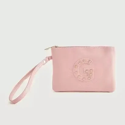 Gloo Studded Alphabet G Pouch, open with zipper visible. Silver pouch with black studs forming the letter 'G'. Wrist strap attached with tag.