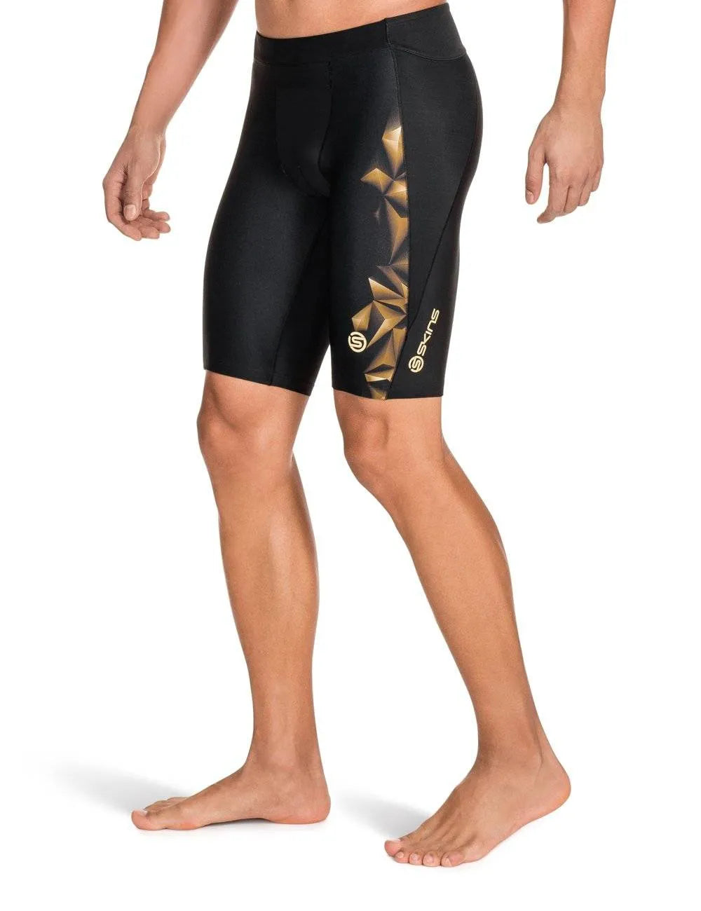 Men's black and gold Skins A400 1/2 tights with compression technology for performance and comfort.
