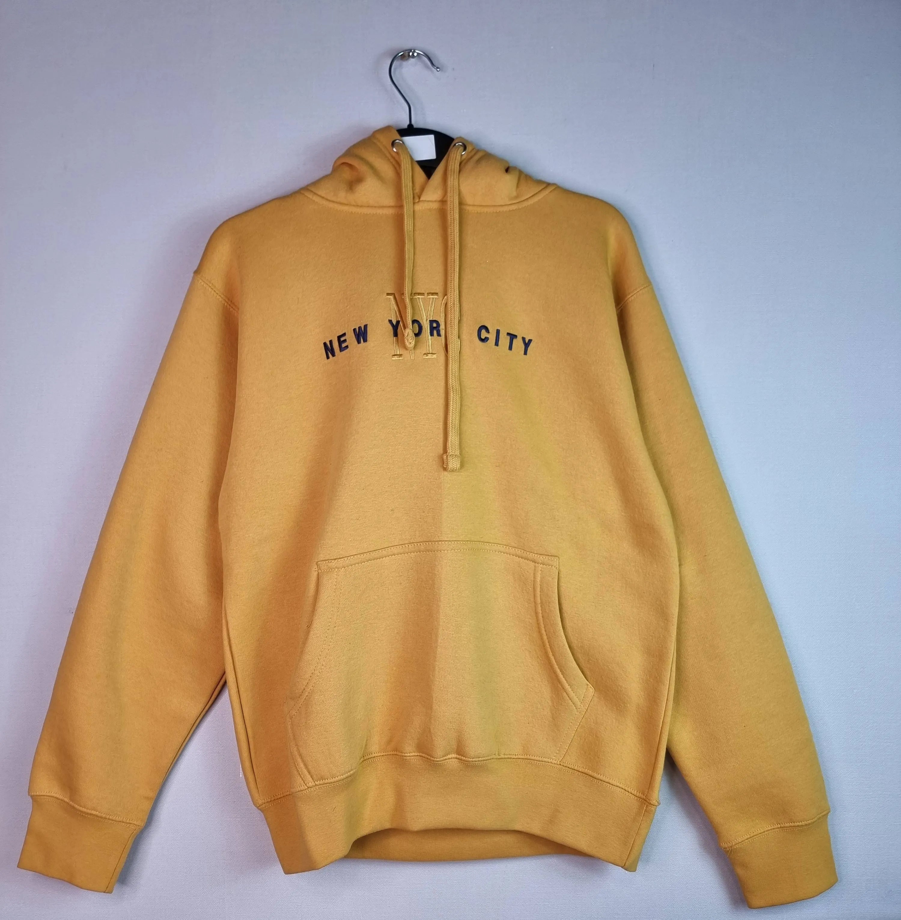  Brighten your day: Stay warm and visible in this cheerful unisex yellow hoodie from Go For It New York.Wrap yourself in the comfort of this NYC-inspired hoodie, wherever you are.