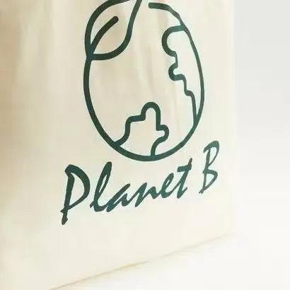 Gloo Planet B printed fold-up shopper bag made from sustainable materials. Bag is folded and displayed against a white background. Gloo Planet B eco-friendly shopper bag with colorful print, folded compactly on a white background. Perfect for reducing plastic waste.