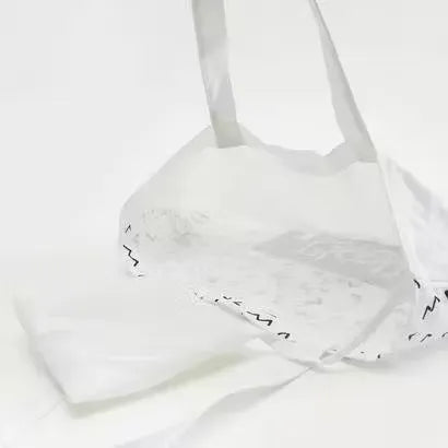 Gloo Planet B printed fold-up shopper bag made from sustainable materials. Bag is folded and displayed against a white background. Gloo Planet B eco-friendly shopper bag with colorful print, folded compactly on a white background. Perfect for reducing plastic waste.