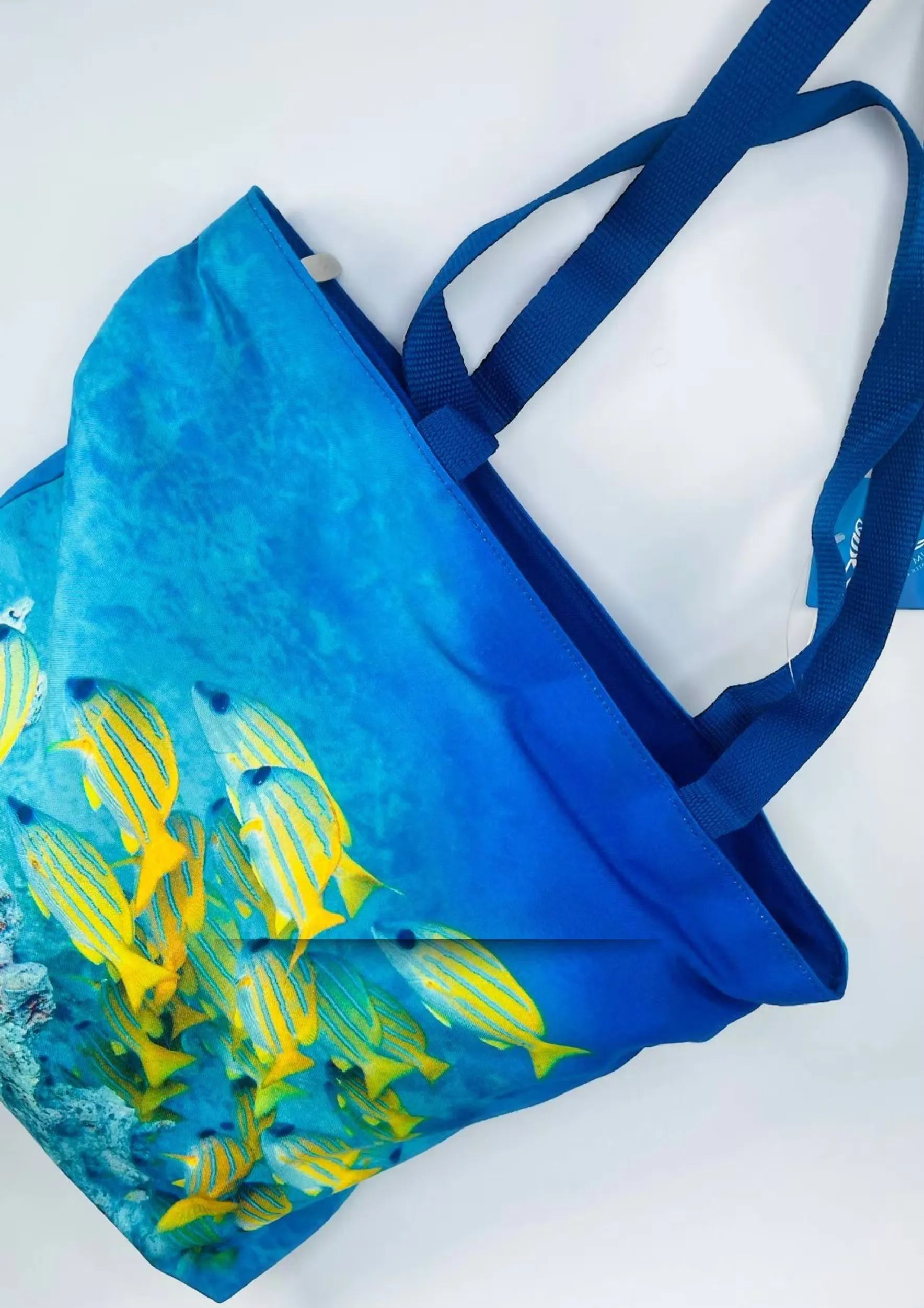 Dubai Aquarium Tote Bag: Blue and white tote bag featuring colorful fish and coral reef design.
