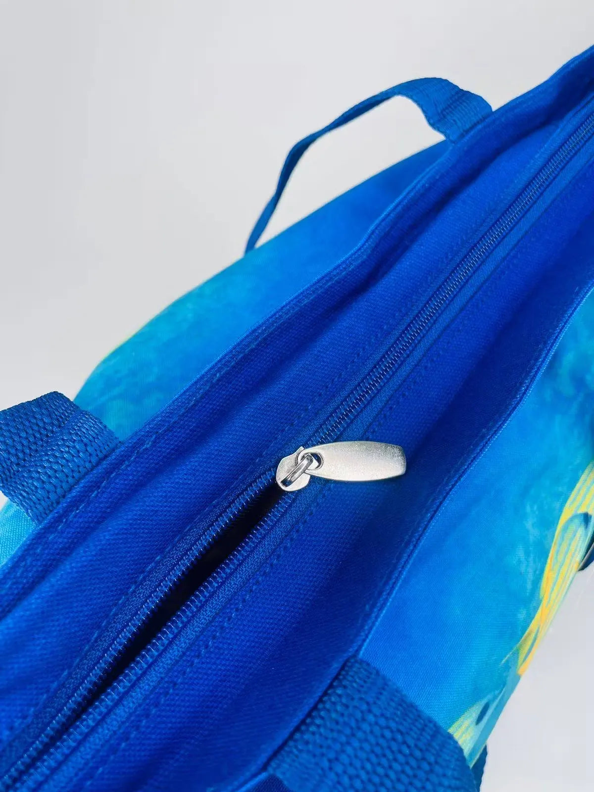 Dubai Aquarium Tote Bag: Blue and white tote bag featuring colorful fish and coral reef design.