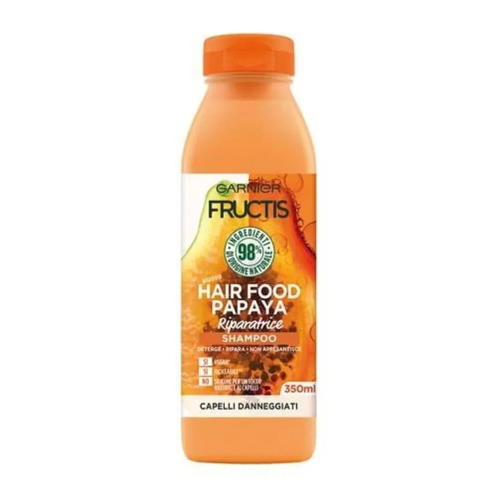 Close-up of Garnier Fructis Hair Food Papaya Shampoo bottle (350ml) with green label and papaya image. Gentle foam flowing from the bottle.