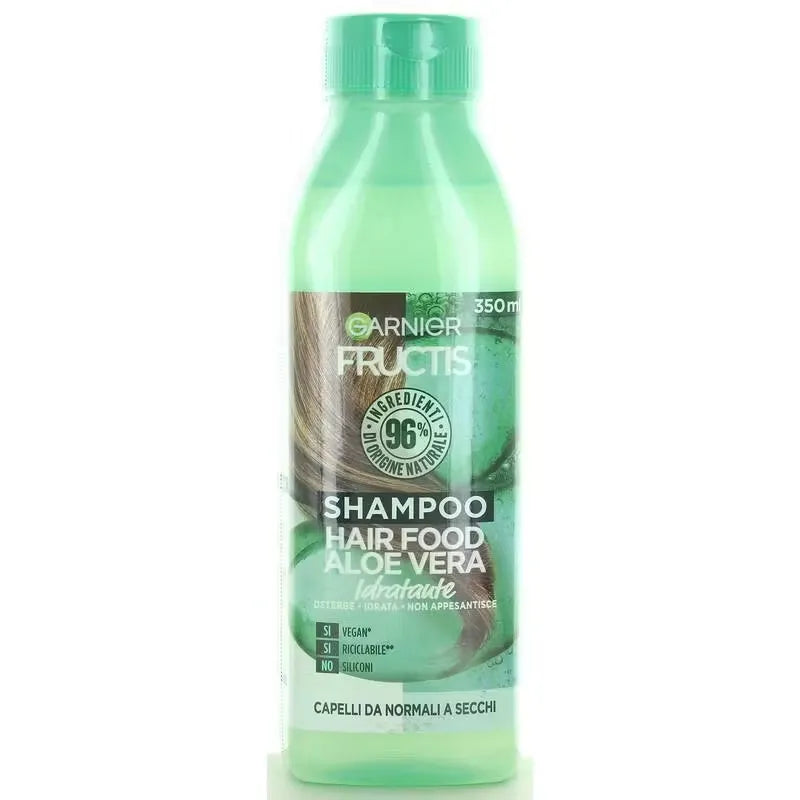 Close-up of Garnier Fructis Hair Food Shampoo bottle (350ml) with green accents and fruit image. Bottle dispenses clear shampoo onto hand.