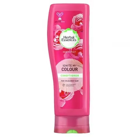 Bottle of Herbal Essences Ignite My Colour Conditioner (400ml) with vibrant colors and rose extract image. Lush, healthy-looking hair flowing down a woman's shoulders.