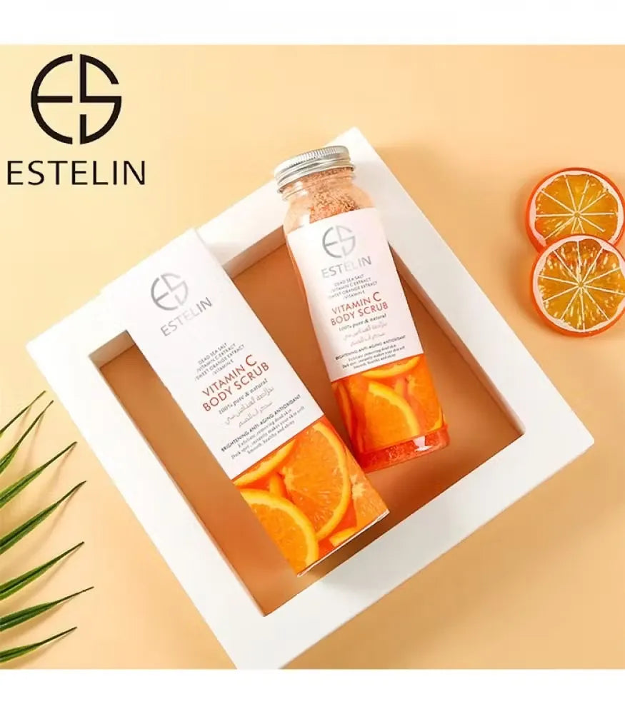 Close-up photo of Estelin ES0005 Vitamin C Body Scrub container with orange accents. Scrub being scooped out, revealing orange sugar-like texture.