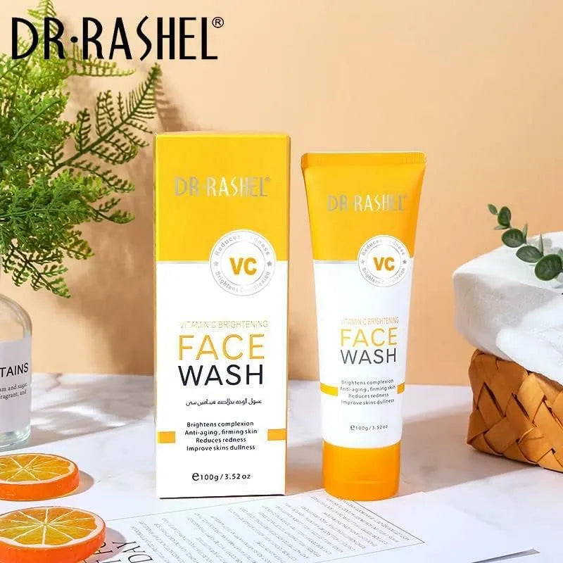 Close-up photo of Dr. Rashel Vit C Face Wash 100g tube with orange accents and orange slice image. Creamy face wash being dispensed onto hand.