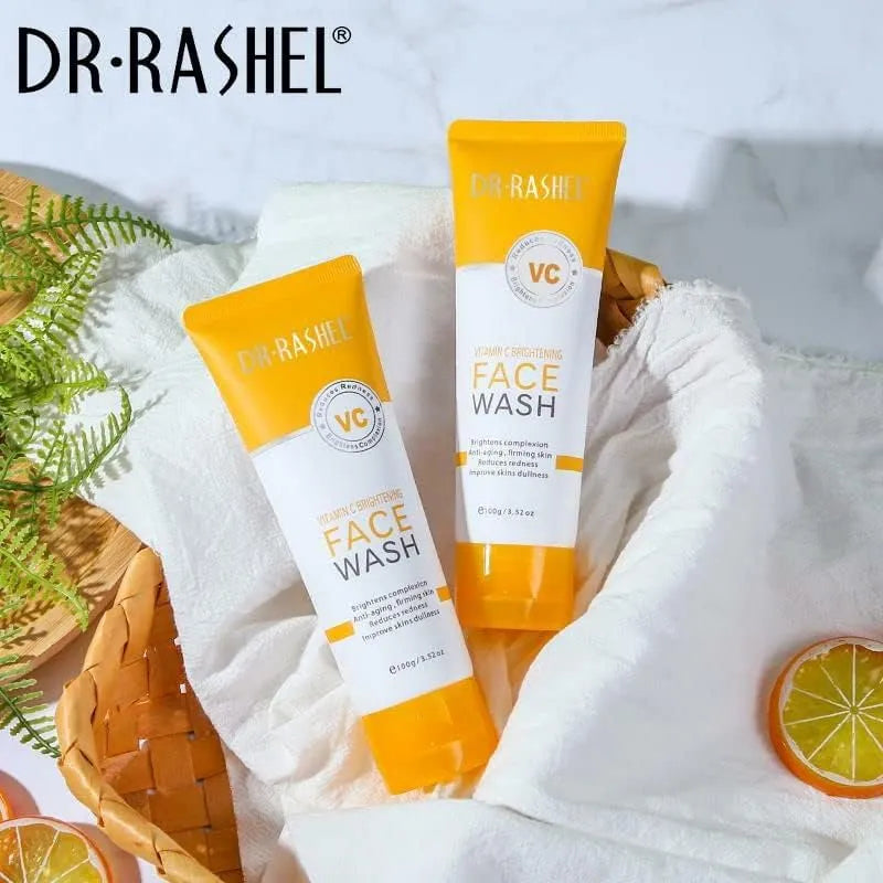 Close-up photo of Dr. Rashel Vit C Face Wash 100g tube with orange accents and orange slice image. Creamy face wash being dispensed onto hand.