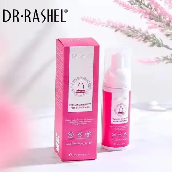 Close-up of white bottle with pink accents labeled "Dr. Rashel Feminine Intimate Foaming Wash - 60ml." Gentle foam being dispensed onto hand.