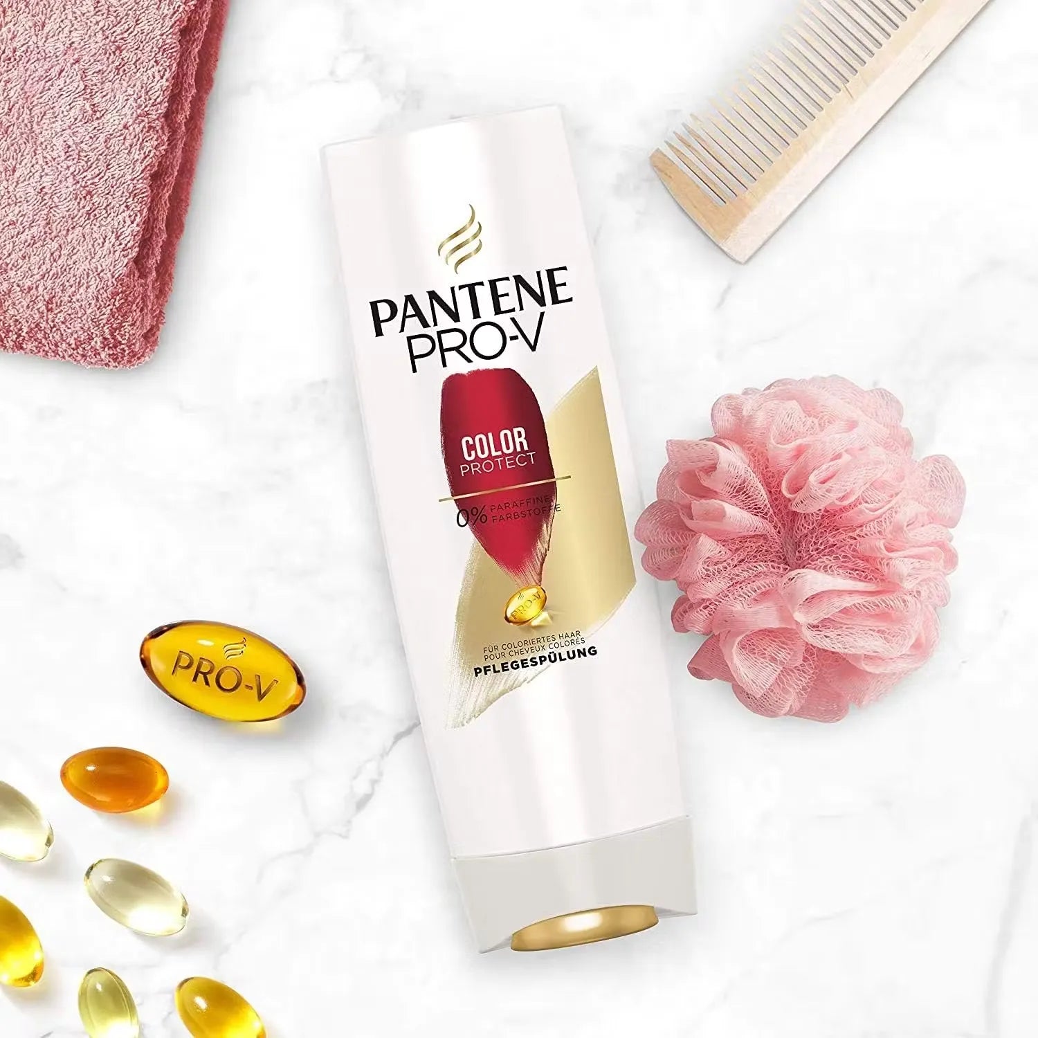 White bottle with blue accents and "Pantene Colour Protect Conditioner" label. Gentle foam being dispensed onto hand.