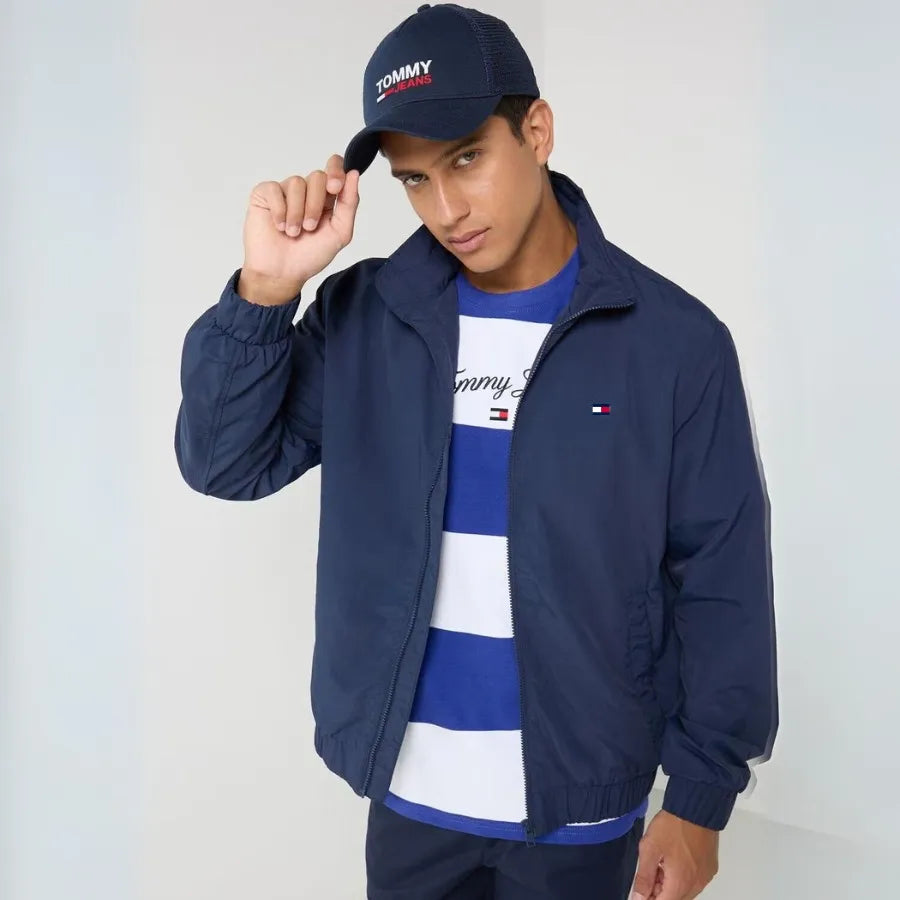 Men's navy jacket by Tommy Hilfiger, taffeta fabric, versatile style.Experience a luxurious feel and timeless design with the Tommy Hilfiger navy taffeta jacket, crafted from premium fabric.