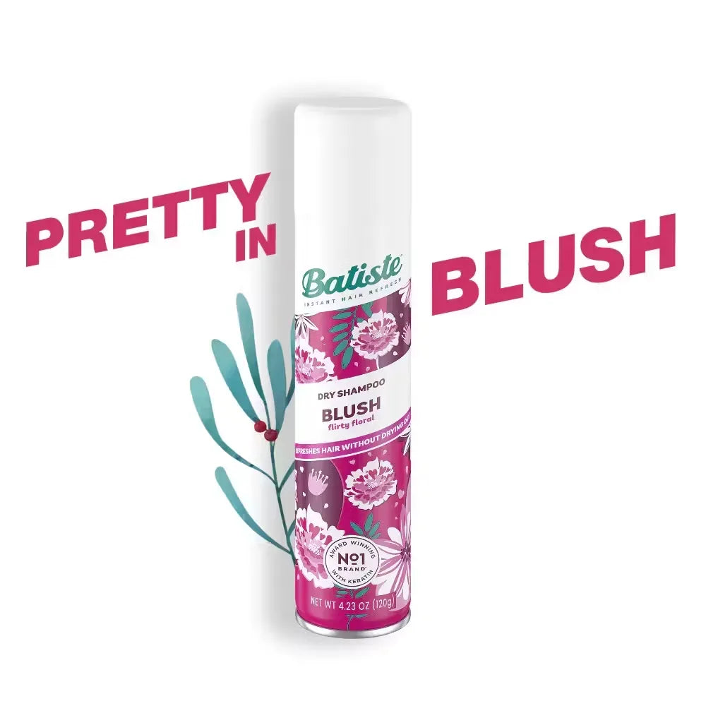 Pink and white can of Batiste Dry Shampoo in Blush fragrance (200ml) held in a woman's hand.