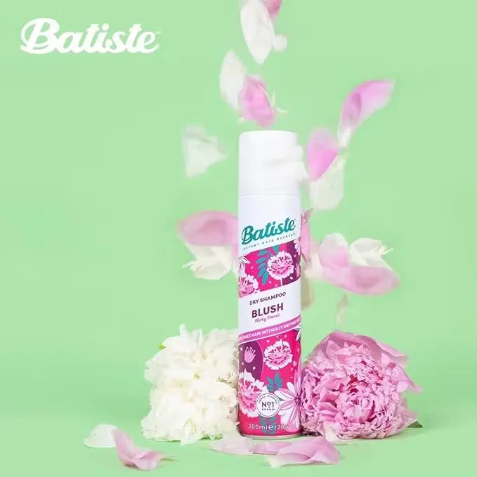 Pink and white can of Batiste Dry Shampoo in Blush fragrance (200ml) held in a woman's hand.