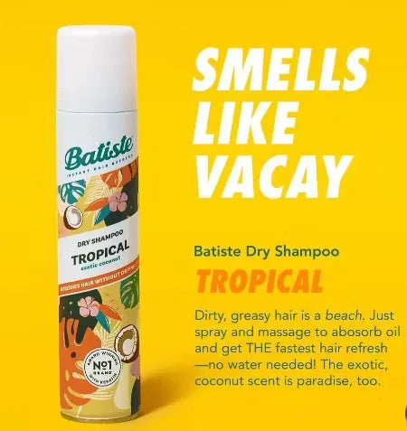 Canister of Batiste Dry Shampoo (200ml) in tropical design with a palm tree and coconut. A puff of powder is dispersing from the nozzle.