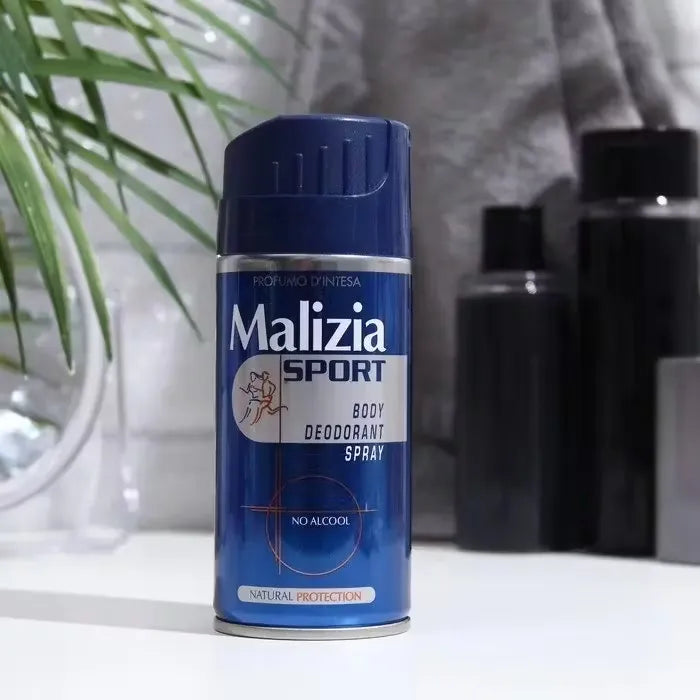 Blue Malizia Sport Body Deodorant Spray bottle with silver accents, spraying onto hand.