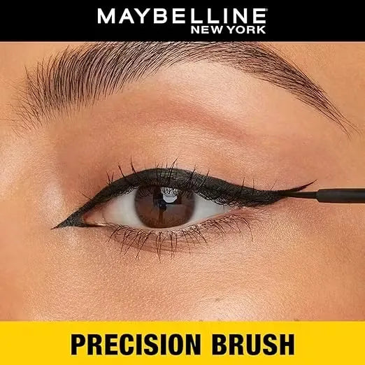 Close-up photo of Maybelline New York Colossal Bold Eyeliner pen in black with gold accents, held against a white background.