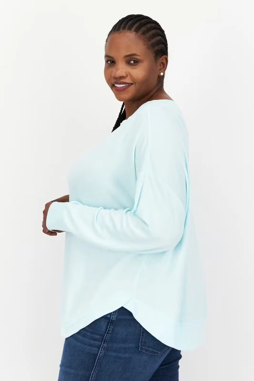 Aqua green, long-sleeve crewneck pullover top made from soft, modal fabric. Model wearing the top with relaxed fit and thumbhole cuffs.