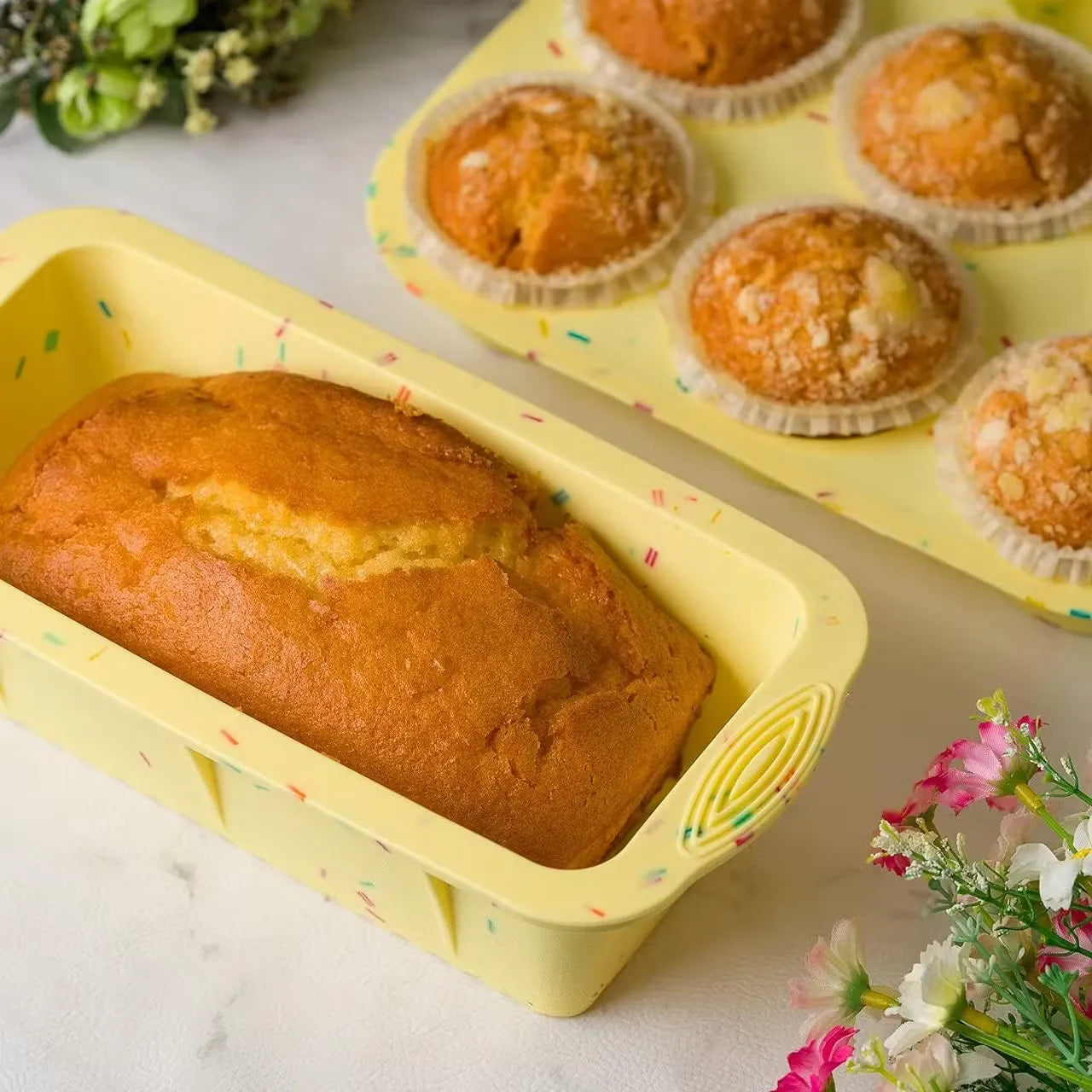 Insiya 2-in-1 baking pan made from material with number muffin cups and a rectangular baking area. Bake sweet and savory treats with ease using the Insiya 2-in-1 pan! Muffin cups and baking tray combined for space-saving convenience