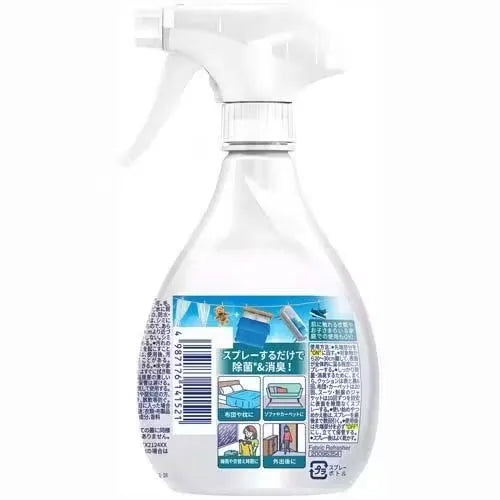 Close-up of Febreze Anti-bacterial Fabric Spray bottle (370ml) with fresh scent design. Spraying the mist onto a colorful couch.