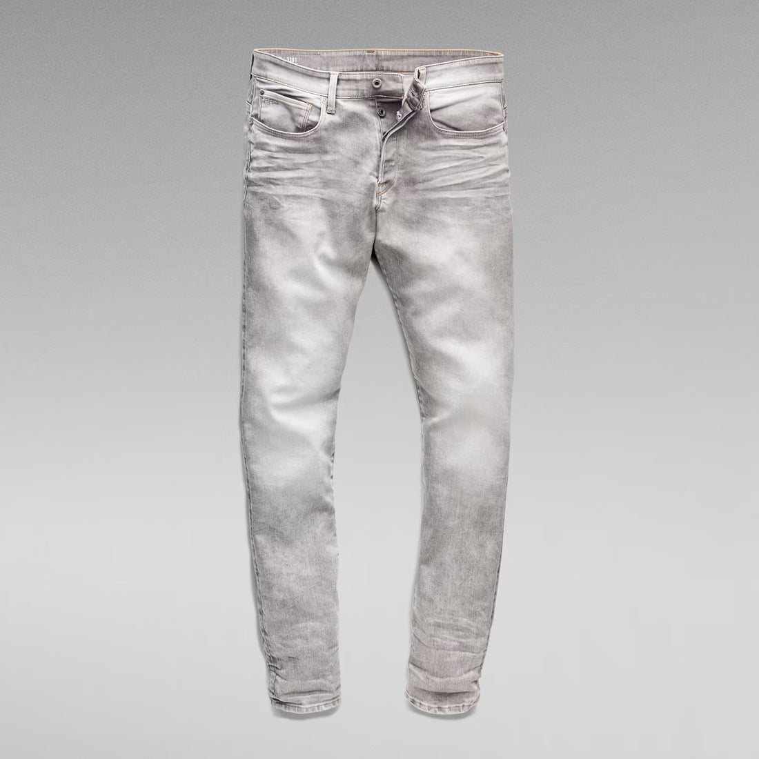 Unfolded front view of the grey tapered jeans on a solid background.