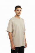 Man wearing beige oversized t-shirt
