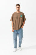 Man wearing brown oversized t-shirt