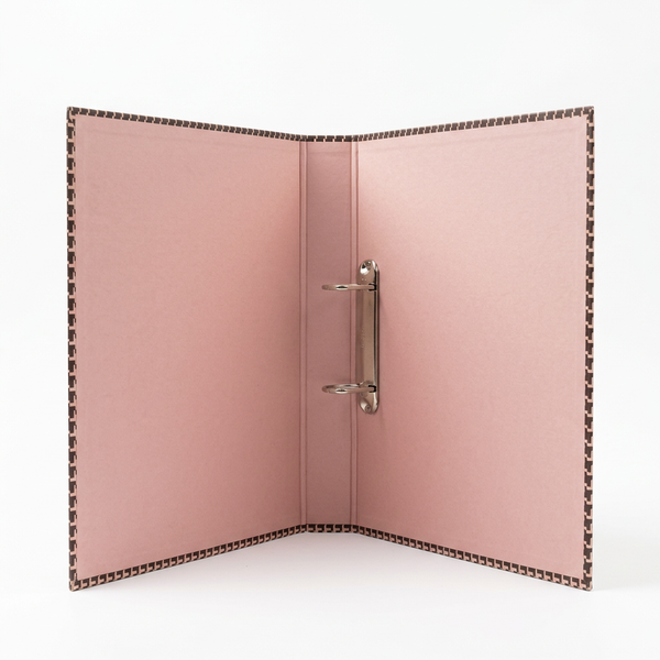 Open pink ring binder on a clean white studio background