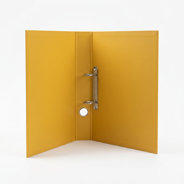 Open yellow two-ring binder on a clean white studio background