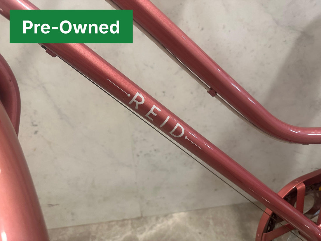 Reid logo on the rose gold step-through frame