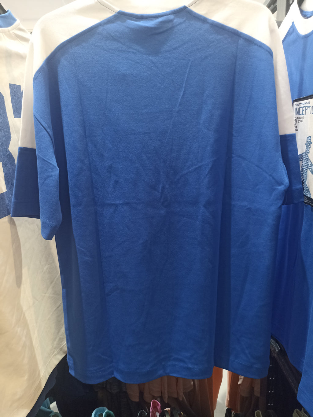 Blue and white T-shirt featuring the movie "Inception" graphic.