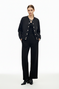 Woman wearing black cardigan and wide-leg trousers