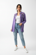 Woman wearing purple embellished shirt